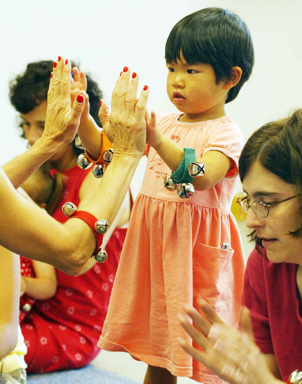 A child giving a high five to a grownup.